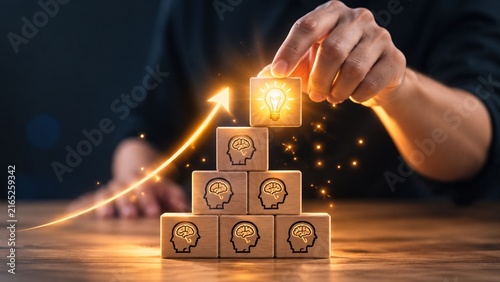 Hand stacking wooden blocks with lightbulb and swift growth arrow for business innovation concept