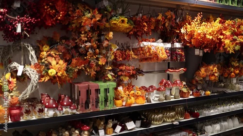 Autumn store display filled with pumpkins maple leaves berries mushrooms wreaths and seasonal decorations creates a cozy fall harvest atmosphere for festive home decorating