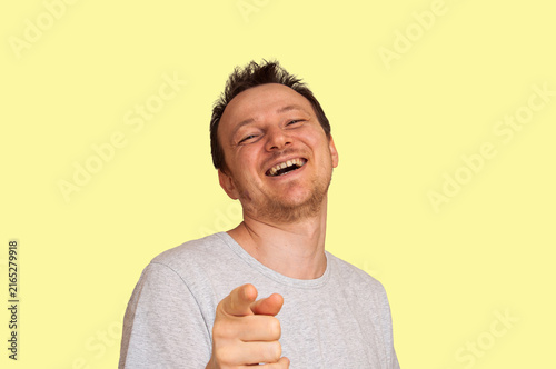 Canvastavla Man laughing heartily and pointing finger at viewer with joy