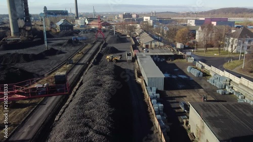 A drone flies around an industrial crane as a loader fills a truck with coal in the Czech Republic.