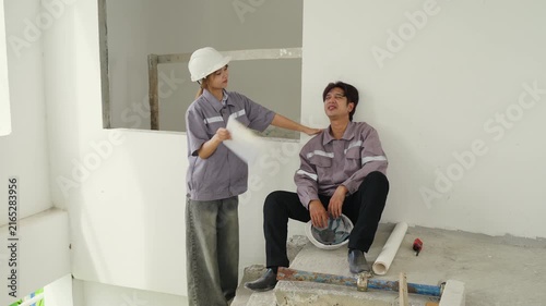 Construction inspector with safety helmet discussing blueprint and project planning at building site showing teamwork and communication among workers for industrial structure support