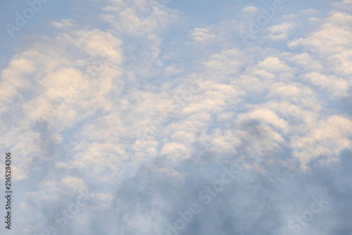 Altocumulus patterned clouds spreading over blue sky in daytime background