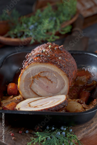 Sliced rolled roast pork with braised vegetable in a pan