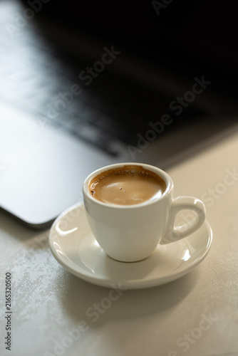 Espresso Coffee Cup on Desk with Laptop – Cozy Modern Workspace and Productivity Concept
