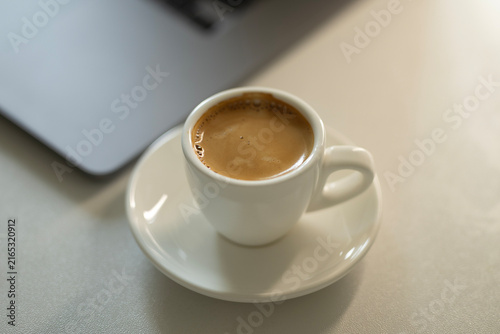 Espresso Coffee Cup on Desk with Laptop – Cozy Modern Workspace and Productivity Concept
