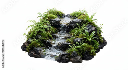 Miniature indoor water fountain with cascading waterfall over dark volcanic rocks and green moss.