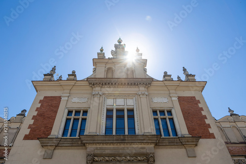 Symmetric Facade of Sukiennice Cloth Hall with Sun Flare in Krakow