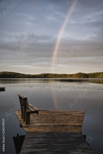 Wooden Pier with Bench at Lake Under Double Rainbow