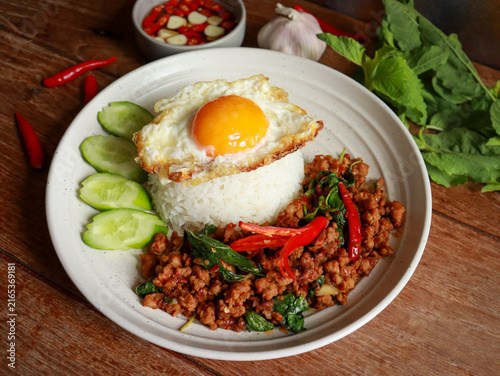 Stir-fried minced pork with Thai basil and a fried egg on rice. Pad kra pao authentic Thai food.