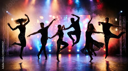 Silhouette Dancers Performing on Stage with Dramatic Lighting.