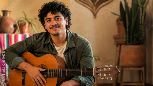 Young Guitarist Portrait in Warm Cultural Home Setting
