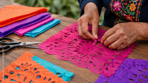 Hands Crafting Colorful Papel Picado Decorations
