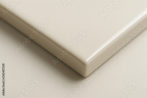 Minimal beige product pedestal with soft shadows on clean studio background