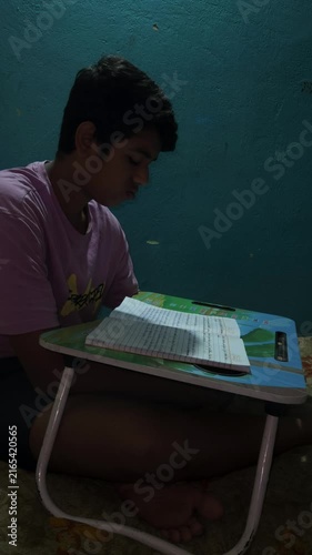 Young Boy Studying at Home with School Book, Child Doing Homework at Desk, Education and Learning Concept, Student Reading Textbook, Concentration, Childhood Development and Academic Study