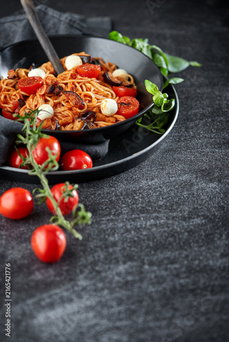 Italian pasta alla norma with cherry tomatoes and mozzarella