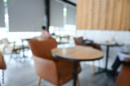 softy blurred view of a modern cafe or lounge interior featuring comfortable chair and round table