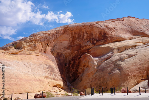 Famous Atlatl Rock picnic area and sandstone cliff face under blue sky in Valley of Fire State Park, Nevada, USA.
