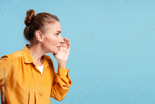 Fotografie Woman sharing secret information whispering a rumor