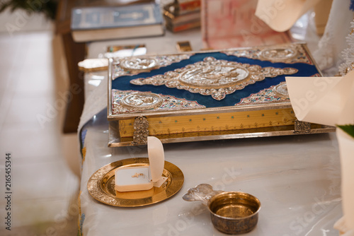 Ornate Blue Velvet Religious Book with Silver Filigree on Altar with Golden Plate and Sacred Vessel