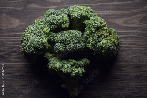 Fresh raw broccoli on wooden table