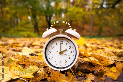 Фотография End of daylight saving time in autumn, winter time changeover, alarm clock fall