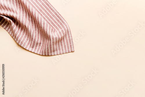 top view with red empty kitchen napkin isolated on table background. Folded cloth for mockup with copy space, Flat lay. Minimal style