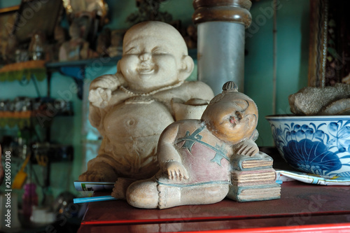 Sleeping child and Hotei figurine, Koh Samui, Thailand
