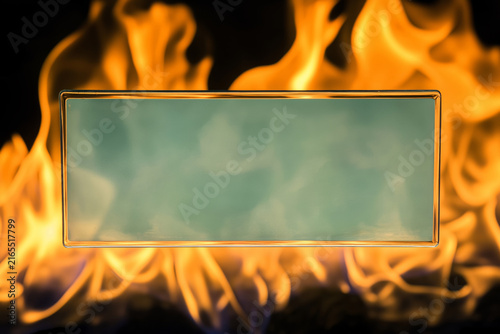 A clear glass rectangle framed by intense orange and yellow flames on a black background.