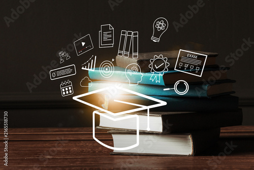 Plakat w ramie E learning materials and tools are placed on a table with a light effect and educational icons in the background