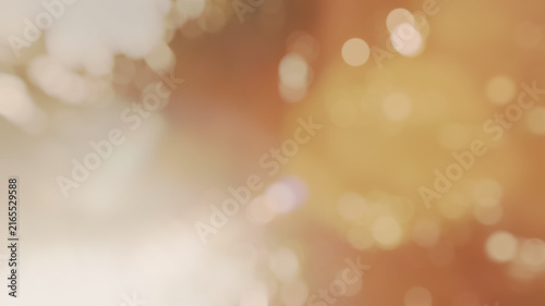 Abstract warm golden blurred bokeh light background with soft sun glare for festive party backdrop or autumn design