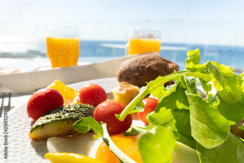 Sea view dining. Healthy hotel breakfast with sea view on a summer holiday.