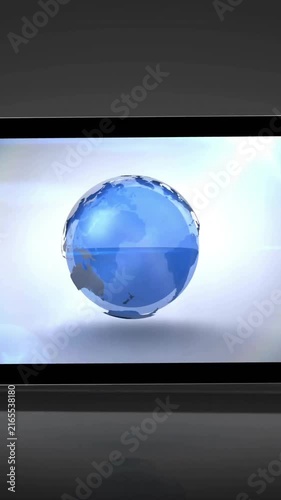 Rotating globe and digital rings animating over tablet screen in close-up view