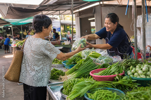 Thai Vegetable Vendor Handing Fresh Local Produce to a Customer during a Lively Morning at an Authentic Neighborhood Market