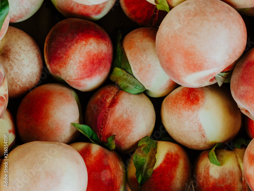 Fresh Ripe Peaches with Green Leaves
