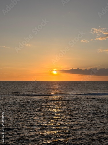Golden Sunset Over Ocean with Sun Reflection on Water
