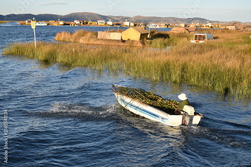 Traditional boat on Lake Titicaca among floating reed islands, Peru