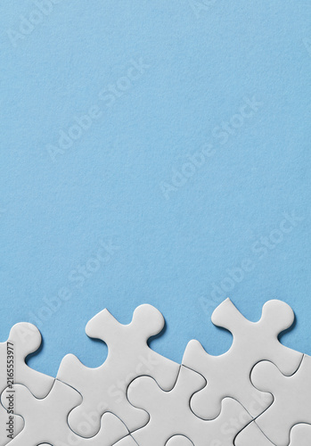 Puzzle pieces along bottom on blue background