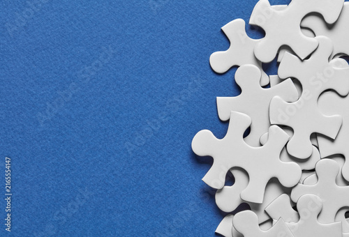 White puzzle pieces on blue background