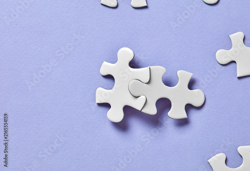 Interlocking puzzle pieces on purple background