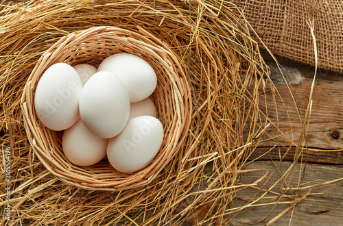 white eggs in rustic nest
