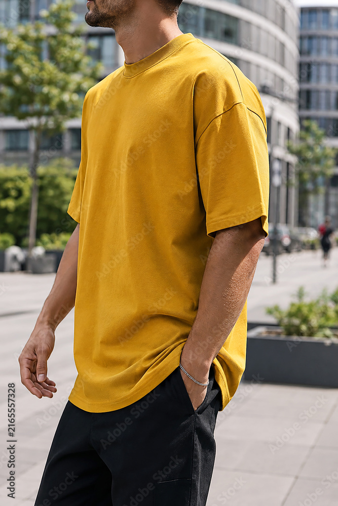 Obraz premium Mustard Yellow Oversized T-Shirt on Male Model in Urban Setting, Generative AI