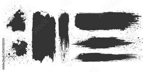 A collection of abstract black brush strokes and paint splatters creates a dynamic, artistic background with a grungy, textured feel, perfect for graphic design.