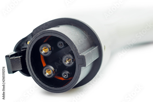 Electric vehicle charging connector with metal pins on white. Electric vehicle charging device.