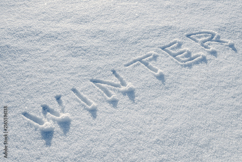 Word Winter handwritten in snow, seasonal background
