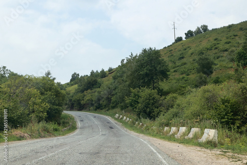 Winding mountain asphalt road with concrete barriers