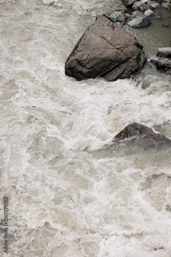 Rushing grey water in a fast mountain river