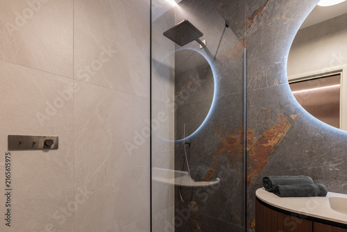 Canvastavla Frameless glass shower featuring enclosure and square rain head dominating, with soft backlighting and indirect ceiling light