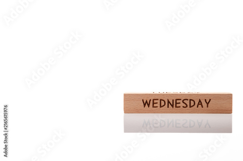 Canvas Print Wooden cube with engraved word WEDNESDAY on white background with soft reflection