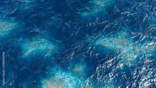 Deep blue ocean surface with underwater light patterns