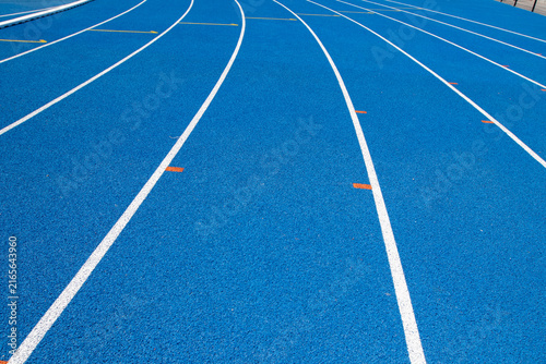 Konstfotografi Blue running track lanes with white painted lines